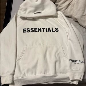 Fear of God Essentials Cream Hoodie with Black Lettering